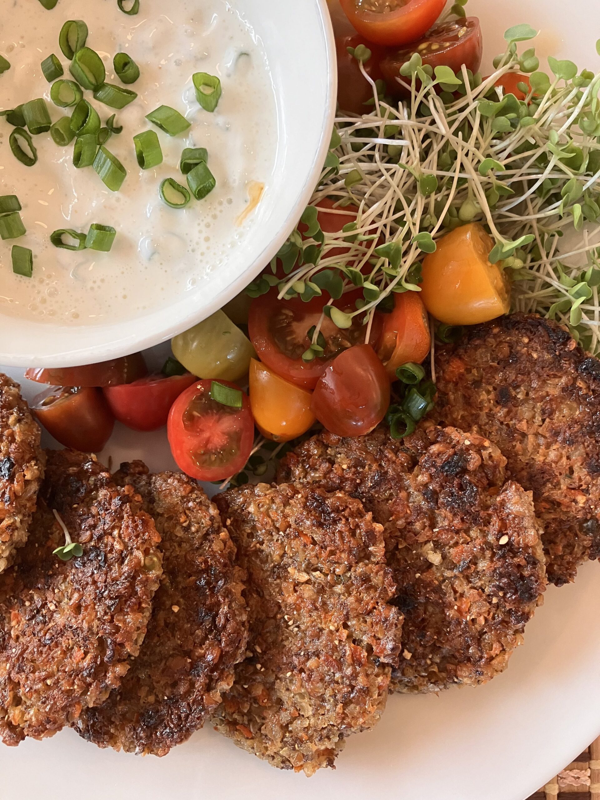 Lentil Fritters, with sour cream dipping sauce, cherry tomatoes, and microgreens