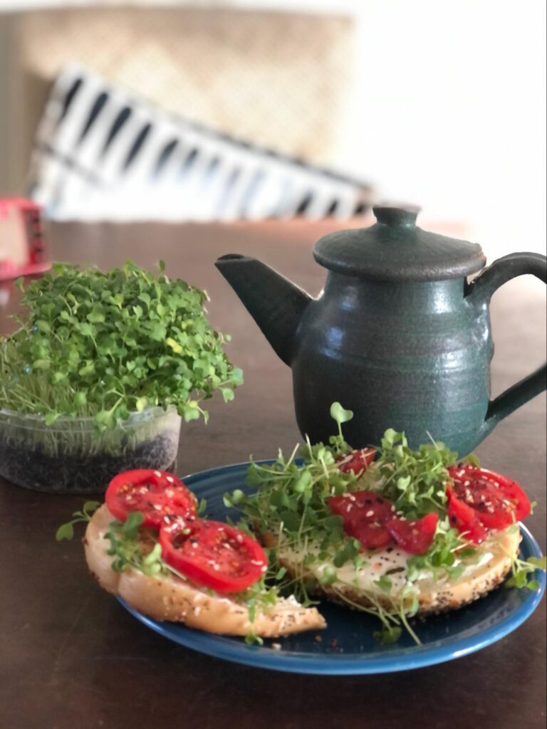 Micro Arugula on a bagel with tomato